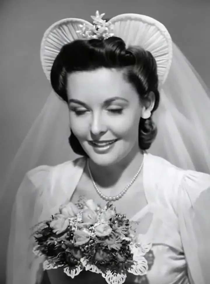 The same bridal portrait with a slight head tilt and a widening smile, illustrating old photo to video AI