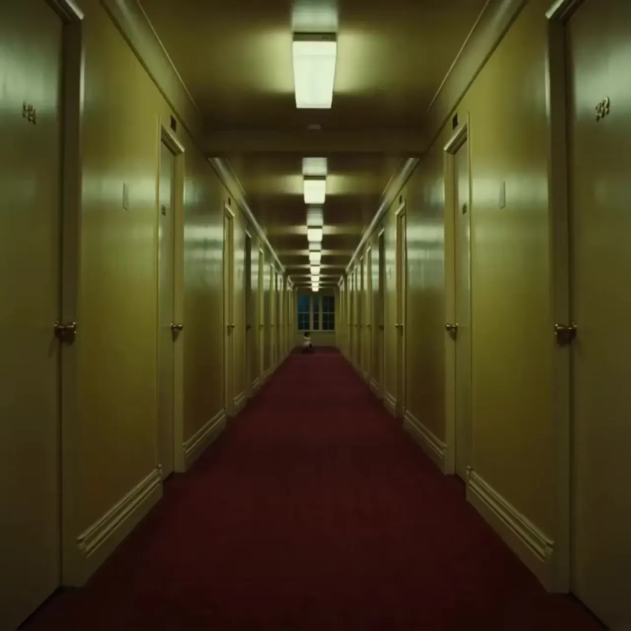 Kling 4.0 release date tracker: a child on a tricycle at the end of a long, empty hotel corridor