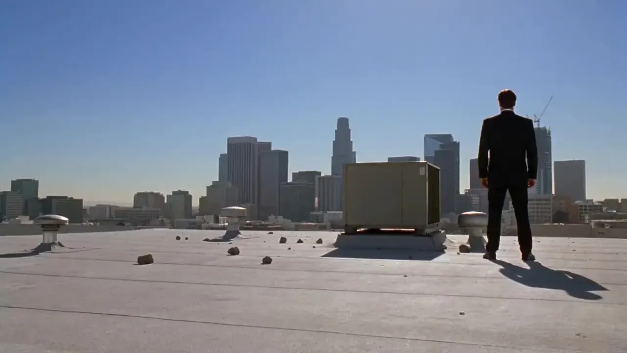 Veo 3 action recipe illustration: a man in a black suit facing off on a sunny city rooftop